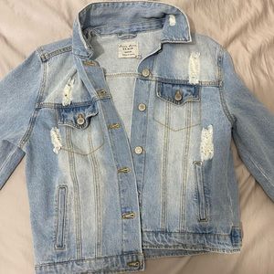 light to medium blue jean jacket with little rips